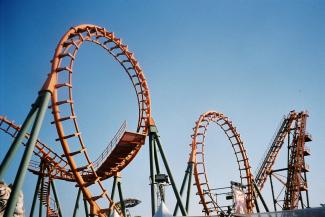 a roller coaster at an amusement park by Somruthai Keawjan courtesy of Unsplash.