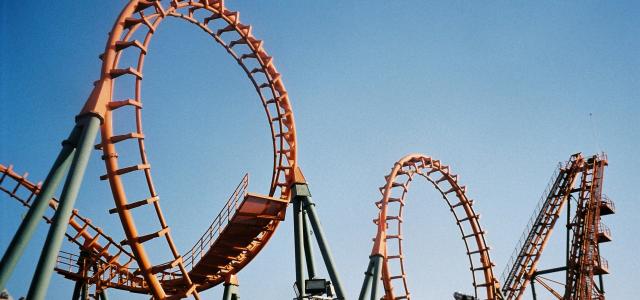 a roller coaster at an amusement park by Somruthai Keawjan courtesy of Unsplash.